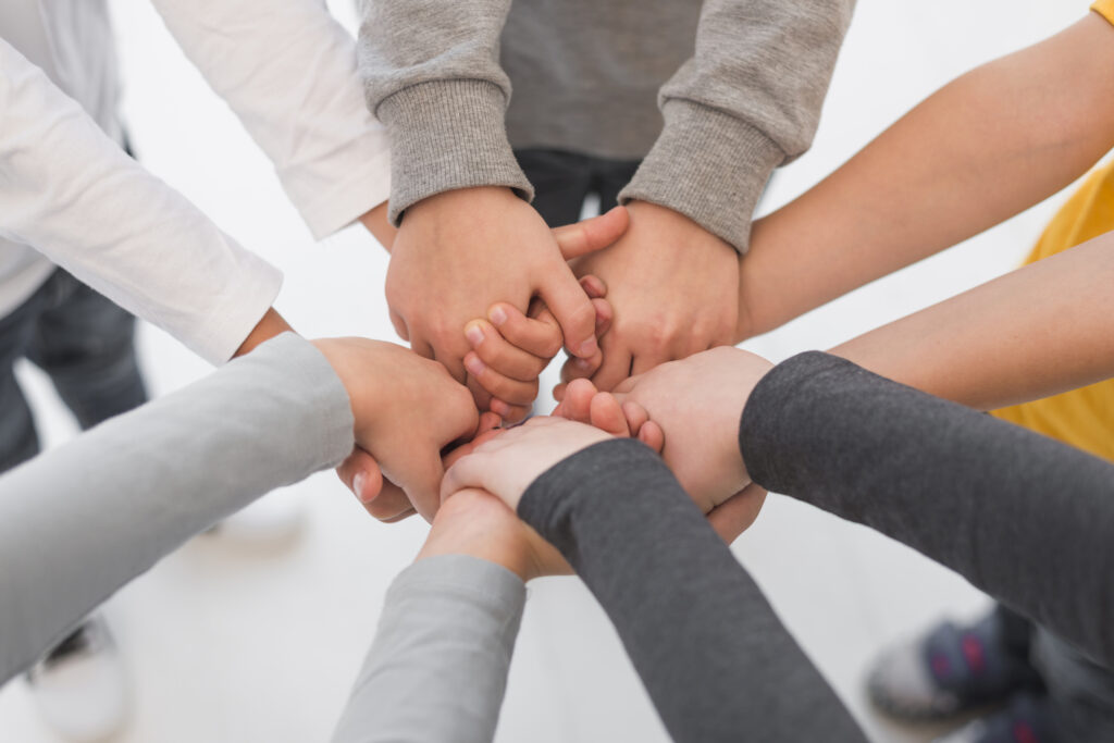 children-with-their-hands-together